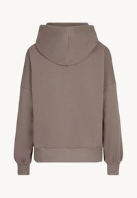 Kaptur z jasnobrązowego materiału, o luźnym kroju, ze obniżonymi ramionami, ściągaczami przy mankietach i u dołu. Gładka tekstura bez widocznych wzorów.