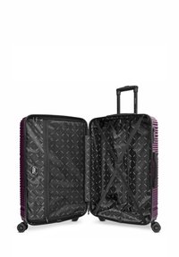 Maleta dura de color púrpura con interior abierto, que cuenta con un forro de tela negra, compartimento con cremallera, correas cruzadas y un asa telescópica con ruedas.