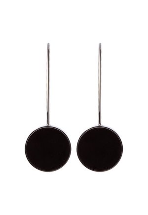 Pair of silver hook earrings with large flat circular black pendants hanging from each hook on a white background.