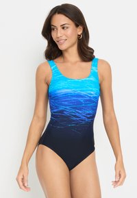 One-piece swimsuit featuring a wave-patterned blue top transitioning to black at the bottom, with a square neckline and thick shoulder straps.
