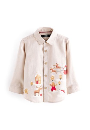 Chemise beige pour enfants avec boutons, imprimée de motifs de Noël incluant le Père Noël, des rennes, un bonhomme en pain d'épice, un bonhomme de neige et des arbres enneigés.