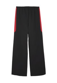 Pantalons larges noirs avec des panneaux latéraux rouges et une taille élastique. Fabriqués en matériau léger, avec deux poches latérales.