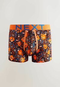 Boxer shorts negros con un vibrante estampado de monstruos en naranja y azul, que cuentan con una ancha cinturilla naranja con la palabra "NEXT" en letras azules y un ajuste cómodo.