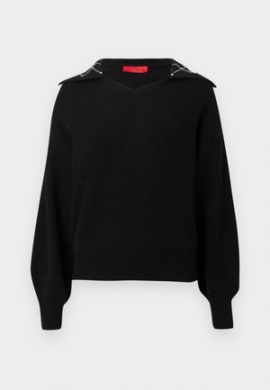 Pull en maille noir avec un décolleté en V et un large col orné de détails argentés. Manches longues et larges avec des poignets ajustés.