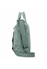 Groene stoffen tas met verstelbare schouderband, gebogen vorm, bovenhandvat en textuur op het oppervlak. Heeft een rits en logo-detail.