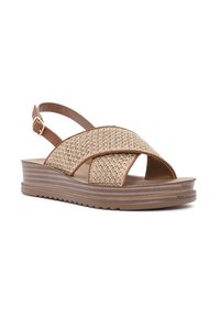 Brown woven sandals with a crisscross design and adjustable ankle strap. Lightweight platform sole with a textured brown finish.