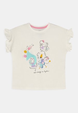 Weißes Kurzarmhemd mit Rüschenärmeln, darauf sind Cartoon-Tiere zu sehen, die Instrumente spielen, sowie der Text "Musik bringt uns zusammen".