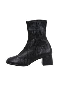 Bota de cuero negro hasta el tobillo con un acabado texturizado, puntera cuadrada y un bajo tacón en bloque. Los detalles de costura añaden estructura al diseño.