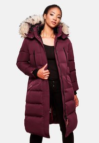 Long puffer coat in deep burgundy with a fur-lined hood, zippered pockets, and quilted texture, featuring a front zip closure and stand-up collar.