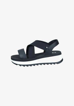 Black platform sandals with cross-strap design, synthetic leather material, textured straps, thick white sole, and zigzag pattern for grip.