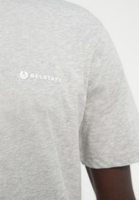 Gray cotton T-shirt featuring short sleeves, a crew neck, and a white "Belstaff" logo on the left chest. Smooth texture.