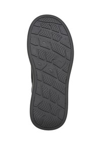 Semelle en caoutchouc noire d'une chaussure avec un motif de bande de roulement texturé comprenant des formes ondulées et géométriques pour l'adhérence.