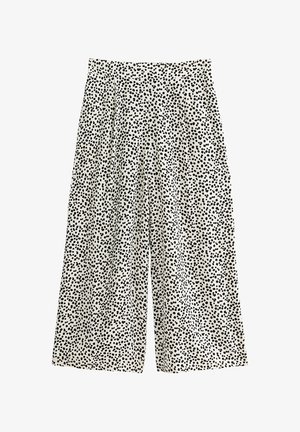 Spodnie w czarno-białe wzory o luźnym, szerokim kroju. Wykonane z lekkiego materiału o teksturowanym wykończeniu.