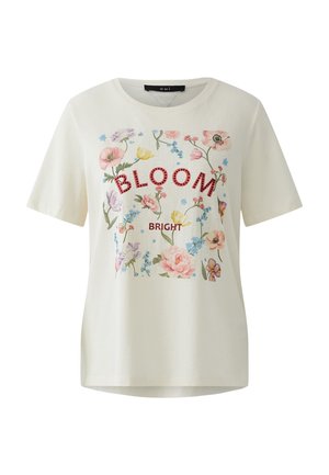 T-shirt blanc à manches courtes avec imprimé floral coloré et texte rouge "BLOOM" et "BRIGHT" sur le devant.