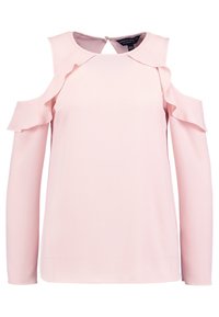 Maglietta rosa pallido a maniche lunghe con aperture sulle spalle, rifiniture a volant sul collo e un dettaglio a chiave sul retro. Tessuto morbido.
