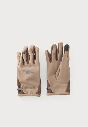 Paar beige und braune North Face Handschuhe mit touchscreen-kompatiblen Fingerspitzen und Logo auf der Rückseite des linken Handschuhs.
