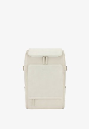 Beiger Rucksack mit strukturiertem Design, ausgestattet mit einem Klappenverschluss, einer Vordertasche, seitlichen Fächern und einer glatten, matten Textur.