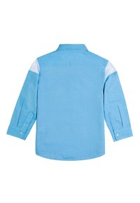 Camicia a maniche lunghe azzurro chiaro con orlo dritto, polsini con bottoni e accenti bianchi a contrasto sulle spalle. Realizzata in tessuto testurizzato.