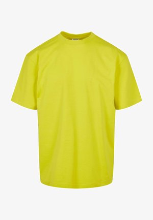 Uniseks majica s kratkimi rokavi v svetleči neonsko rumeni barvi, izdelana iz mehkega blaga s sproščenim krojem in rebrastim okroglim izrezom.