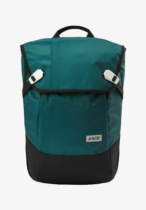 Teal and black rectangular backpack with flap secured by two white buckles and a top handle, featuring a small rectangular brand logo.