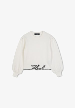 Witte trui met lange mouwen met opgeblazen mouwen en zwart cursief "Karl"-ontwerp met witte stippen langs de onderzoom.