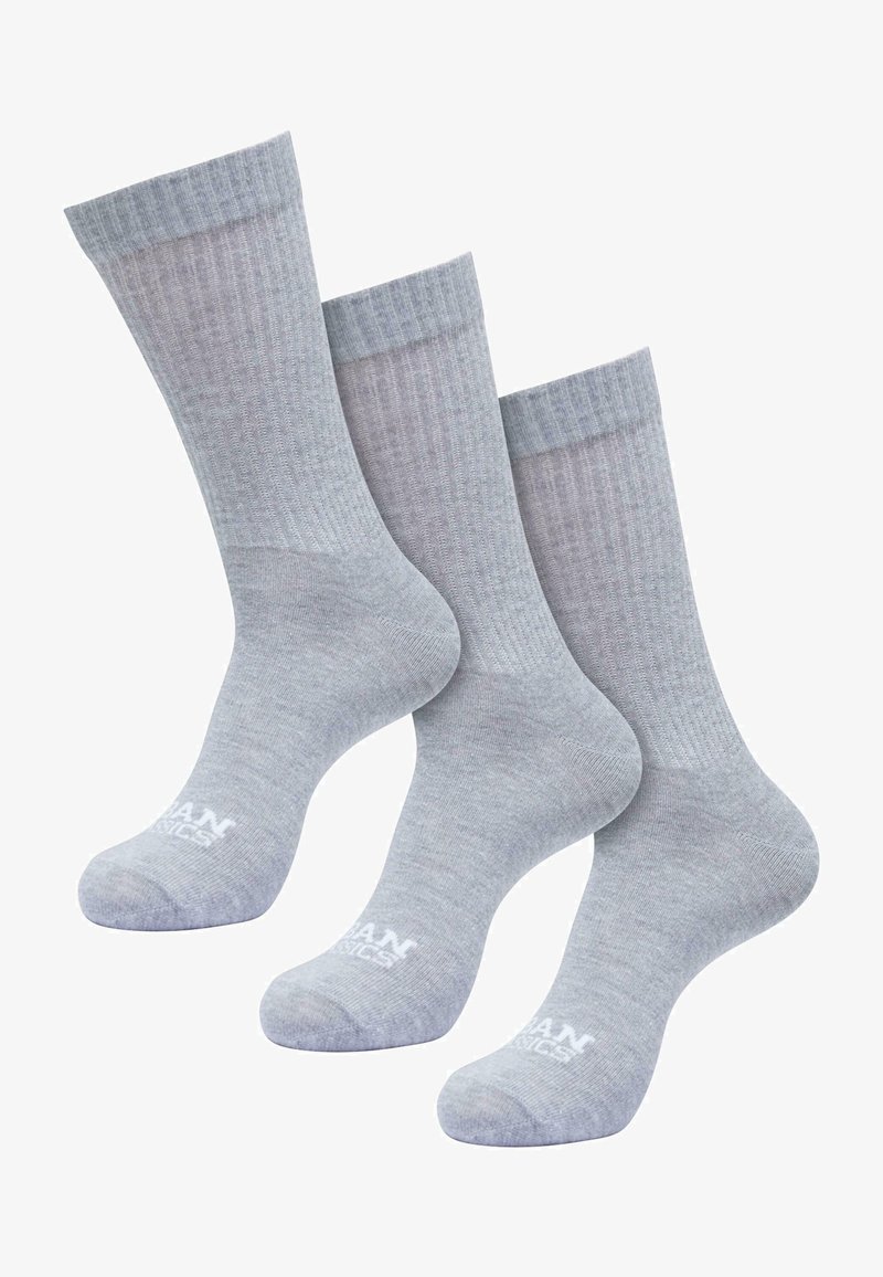 Calzini grigi a coste con una texture liscia, dotati di un bordo superiore di colore contrastante e un logo sulla base. Confezione da tre paia.