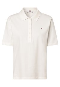 Chemise polo blanche en coton, avec un col classique, une patte de boutonnage et un petit logo brodé sur la poitrine. Manches courtes.