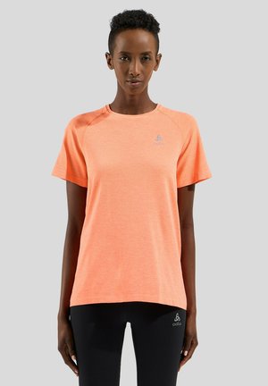Coral short-sleeve athletic shirt made from moisture-wicking fabric, featuring a round neckline and subtle logo on the chest.