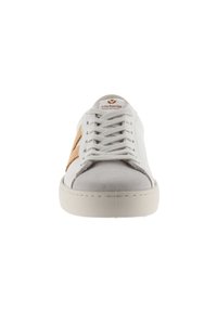 Zapatilla blanca de cuero con acentos de ante beige, cordones planos, punta redonda y suela de goma. Marca presente en la lengüeta. Diseño clásico.