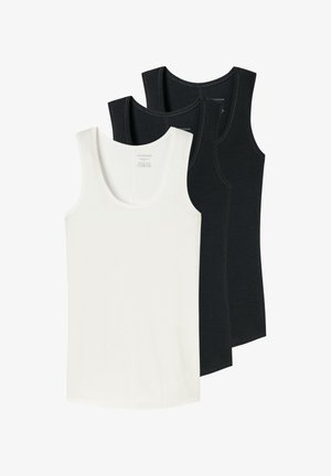Trois débardeurs sans manches en noir et blanc, disposés en chevauchement avec le débardeur blanc au premier plan sur un fond blanc.