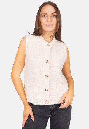 Gilet en laine sans manches de couleur rose clair avec une finition texturée, comportant un col rond, deux poches et quatre grands boutons ronds.