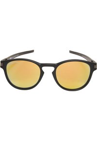 Lunettes de soleil rondes noires avec des verres miroir jaunes et une finition mate. Présentent un design unique avec une découpe au nez et des branches fines.