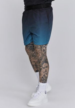 Costumi da bagno da uomo in gradiente blu scuro a verde, realizzati in tessuto leggero. Presentano una vita elastica e tasche laterali.