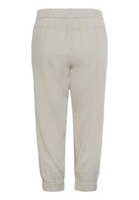 Light beige cuffed pants with elastic waistband, featuring a smooth texture and a relaxed fit. No visible patterns or hardware details.
