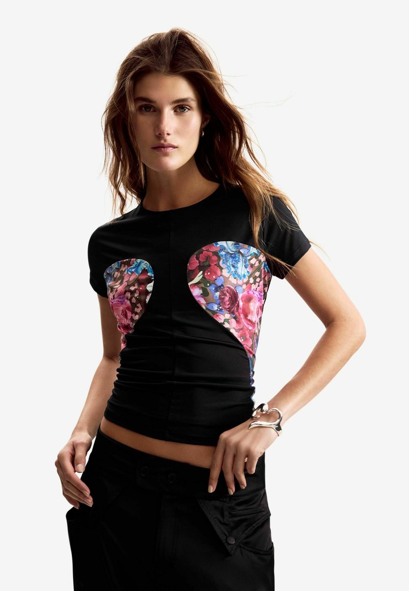 Čierne tričko s kvetinovým vzorom v odtieňoch ružovej a modrej na hrudi, s priliehavým strihom a krátkymi rukávmi.