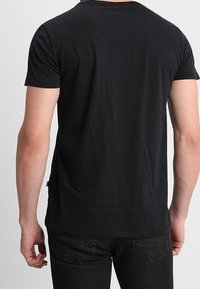 Black short-sleeve t-shirt made of soft cotton. Features a round neckline and a relaxed fit, with minimal detailing and no graphics.
