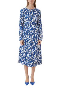 Langes blaues Kleid mit weißem abstraktem Blumenmuster, gerafftem Ausschnitt, langen Ärmeln, fließendem Stoff, kombiniert mit blauen spitzen High Heels.