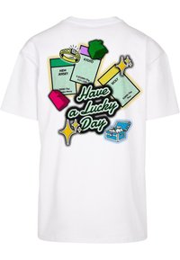 White cotton t-shirt featuring colorful graphic prints, including "Have a Lucky Day" text and game-like elements resembling property cards.