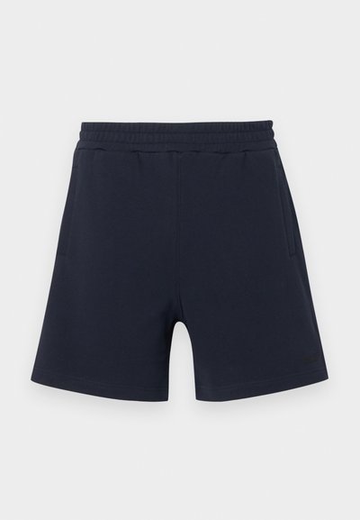 Shorts décontractés bleu marine avec taille élastique et poches latérales, ornés d'un logo discret sur la partie inférieure de la jambe gauche.