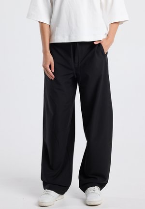 PRIYA - Trousers - black