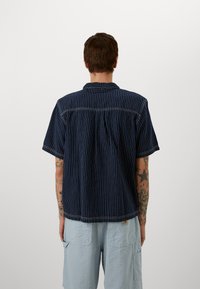 adidas Originals GRAPHIC  - Polo shirt - medium blue denim