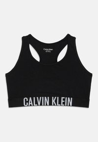 Juodas sportinis liemenukas su lenkiama nugaros dizainu, pagamintas iš minkštos medžiagos. Ypatybė – plati juosta su "CALVIN KLEIN" baltomis raidėmis apačioje.