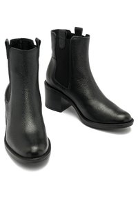 Bottines en cuir noir avec une finition texturée, des panneaux latéraux élastiques et un talon bloc. Design élégant avec un bout arrondi et une quincaillerie minimale.