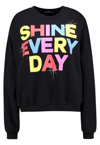 Black sweatshirt featuring bold, multicolored text reading "SHINE EVERY DAY." Classic crew neck and ribbed cuffs and hem. Soft material.