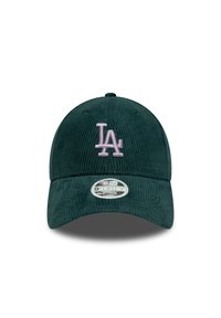 Dark green corduroy baseball cap with stitched "LA" logo in light pink, curved brim, and adjustable strap at the back.