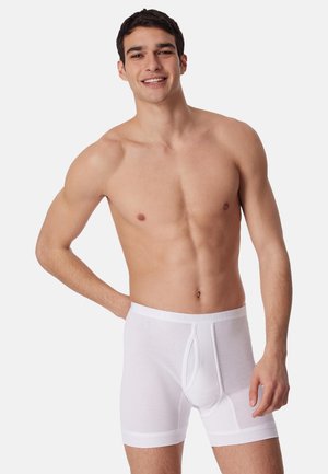 Boxer in cotone bianco con design a coste testurizzato e cintura elastica, con apertura frontale e forma aderente.