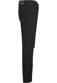 Vaqueros de mezclilla negra con un ajuste slim, que presentan un detalle rasgado en la rodilla, diseño de cinco bolsillos y un acabado mate texturizado.