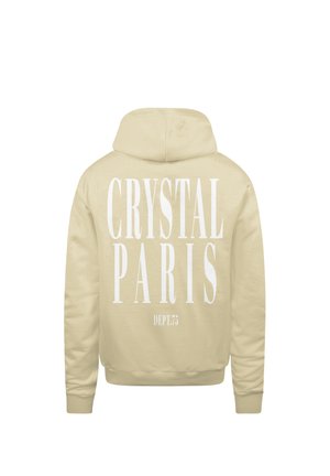 Beige hoodie met grote witte tekst op de achterkant: "CRYSTAL PARIS" en "DEPT.73" in een vette lettertype. Zachte stofstructuur.