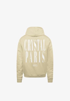 Beige hoodie met grote witte tekst op de achterkant: "CRYSTAL PARIS" en "DEPT.73" in een vette lettertype. Zachte stofstructuur.