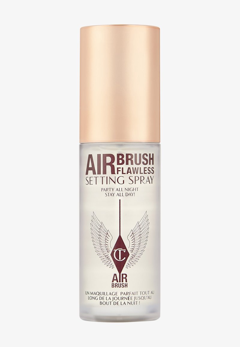 Clear setting spray in a transparent bottle with a gold cap. Features "Airbrush Flawless" text and winged logo. 150ml capacity.